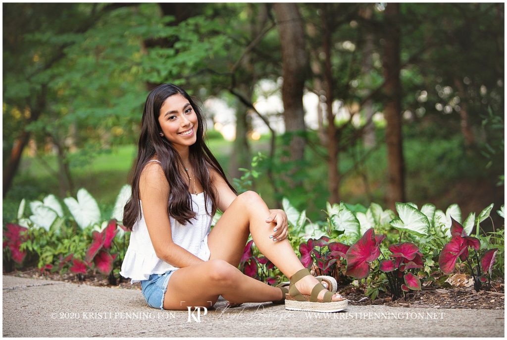 Senior girl sitting with caladiums in Highland Park, Dallas