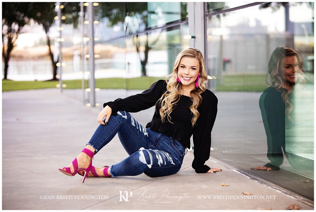 Uptown Girl Senior portraits in downtown Dallas with reflection in glass