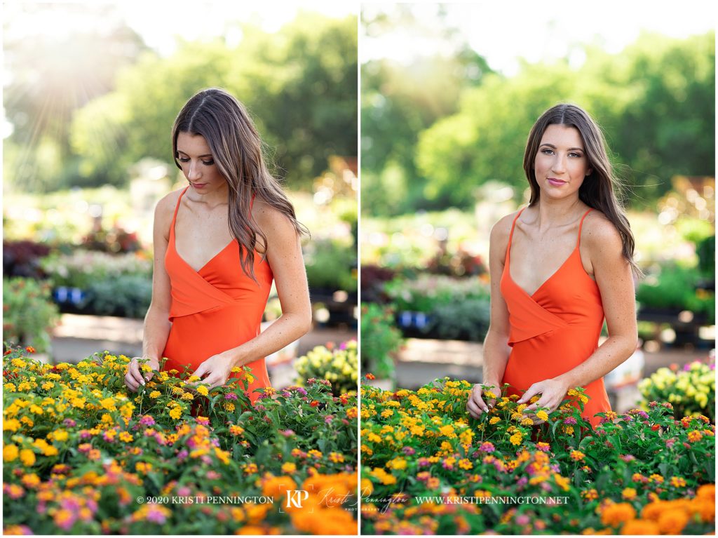 senior girl wearing orange dress with flowers at garden center. 